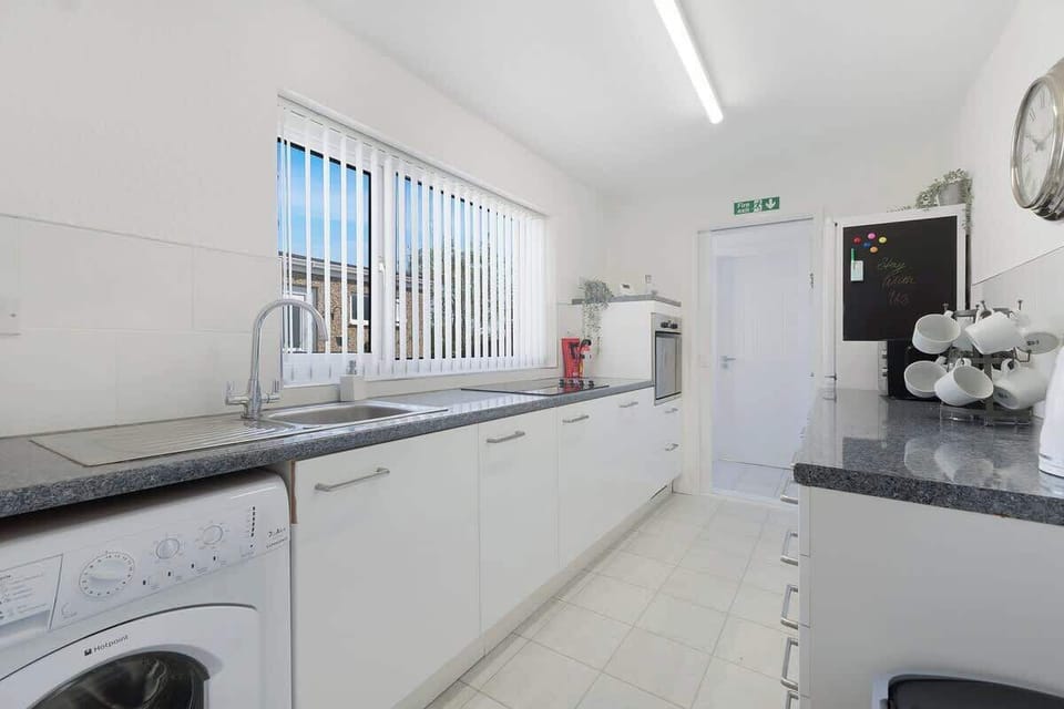 Kitchen equipped with all essentials, including an oven, fridge, and full cookware set.