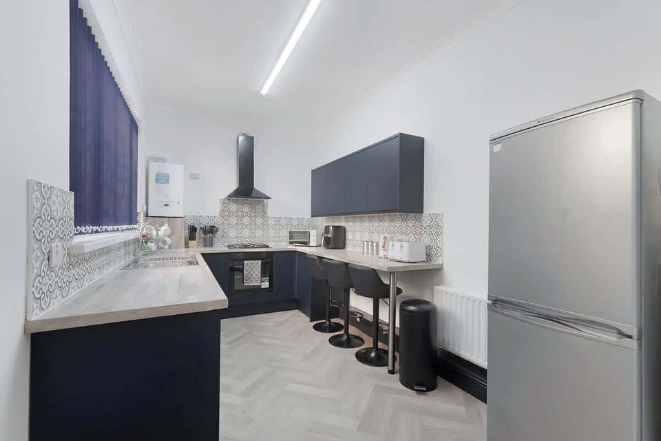 Kitchen equipped with all essentials, including a washer & dryer, oven, fridge and full cookware set.