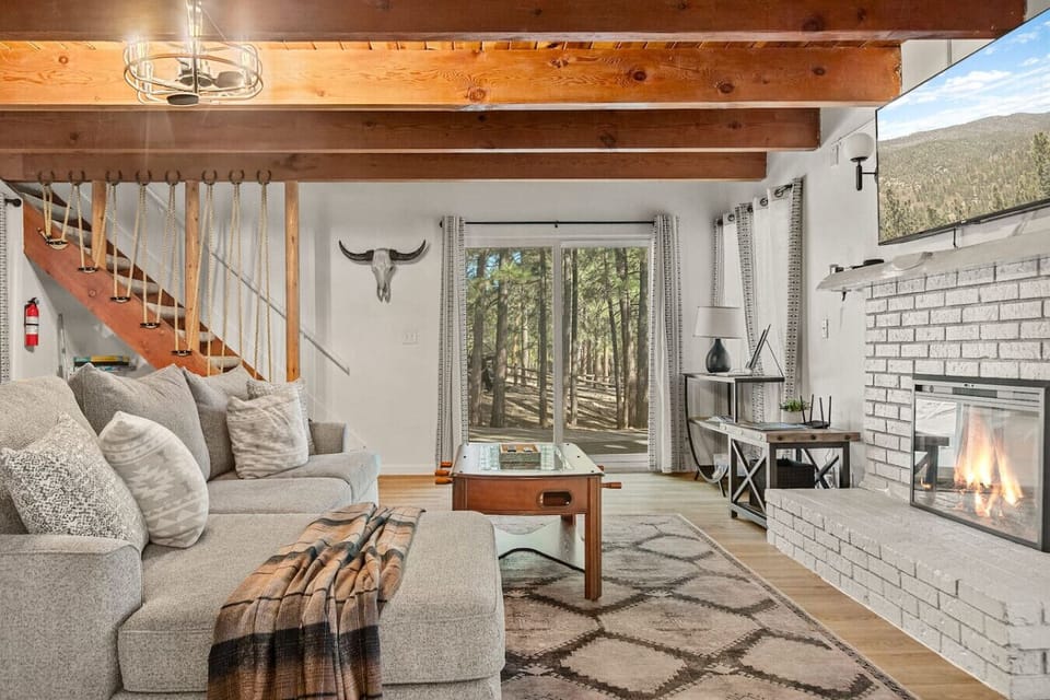 Downstairs is our second living room, complete with a cozy fireplace, foosball table and a comfortable sectional that includes a queen-sized pull-out sofa bed.