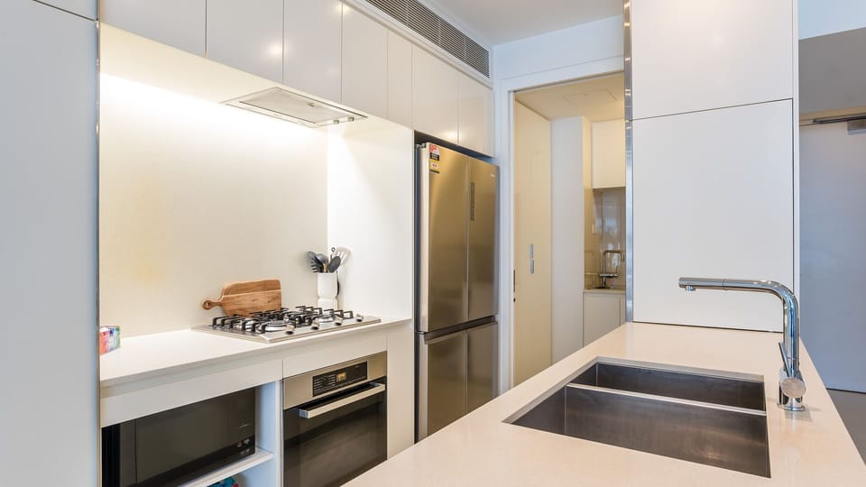 Experience the convenience of a fully equipped kitchen featuring sleek stainless steel appliances and thoughtful touches that make self-catering a breeze.