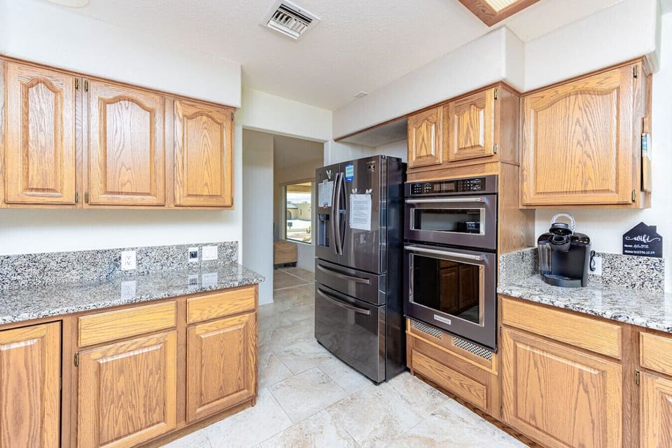 Everything you need for a comfortable stay—fully equipped kitchen with bar seating, two coffee makers, and a high chair for little ones.