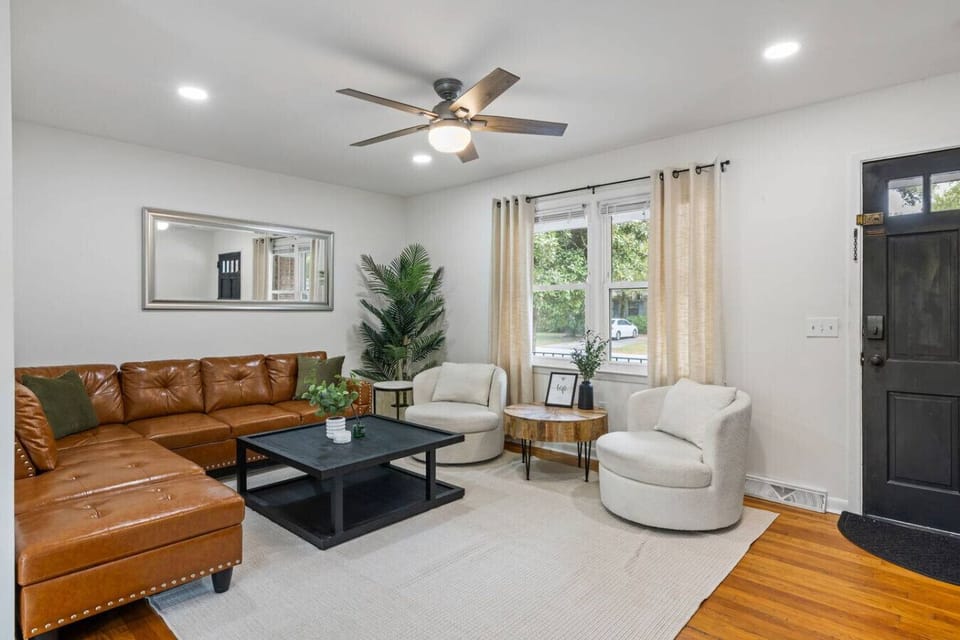 Spacious and stylish living room with plenty of comfy seating—perfect for relaxing after a day exploring Charleston.