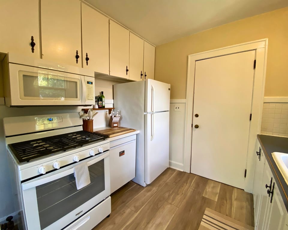 New dishwasher and stove with sharp knives and cutting boards