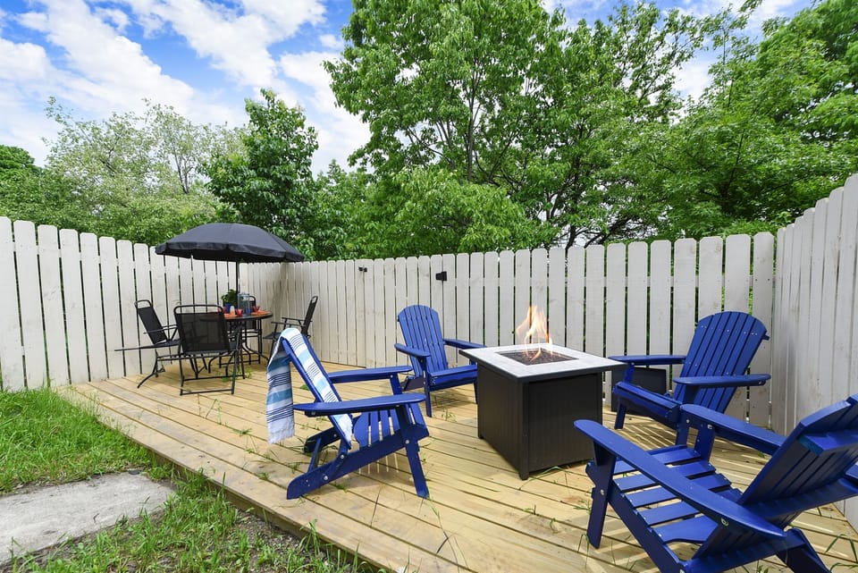Whether it's s’mores by the fire or dinner under the stars, this outdoor setup with a fire pit and patio seating is made for making memories