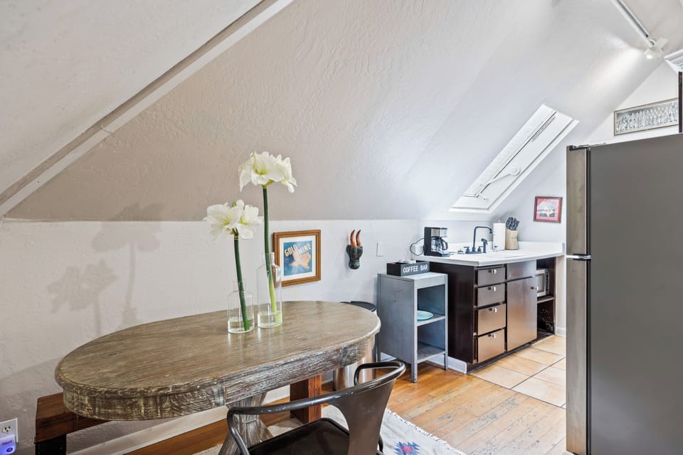 - Compact kitchenette with dining nook and skylight glow  
- Coffee bar setup and rustic details for easy mornings  
- Great for light meals before exploring Main Street shops