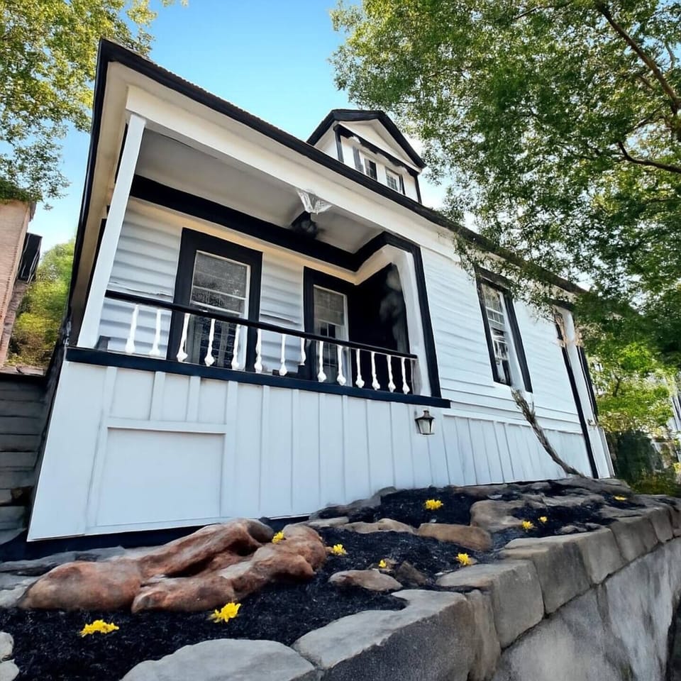 - Restored historic home nestled in scenic Old Town Park City  
- White siding, bold black trim, and natural rock landscaping  
- Combines classic architecture with mountain-town charm