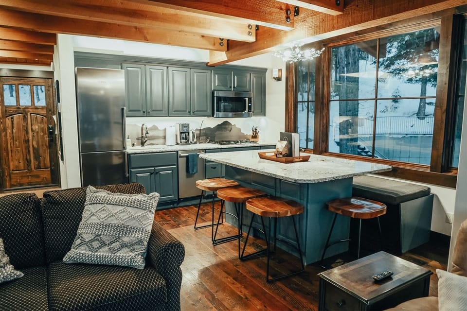 Enjoy a meal before you hit the slopes at the home's expansive kitchen island and dining area | Main Level