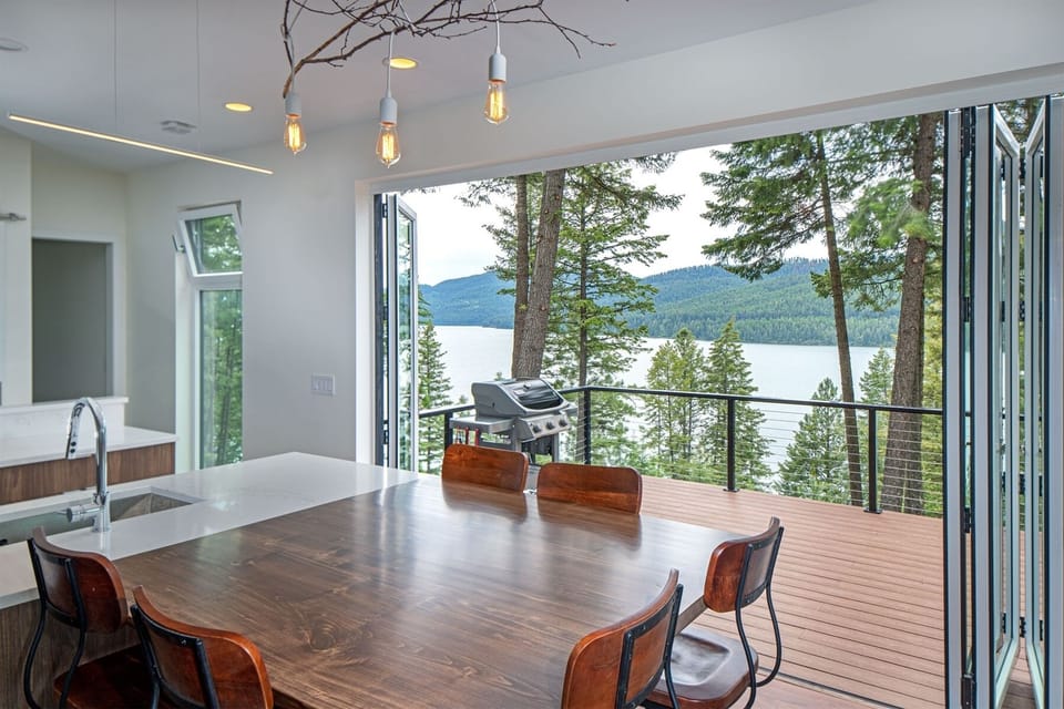 Access the patio from the kitchen and living room, and take in amazing views of Whitefish Lake | Main Floor
