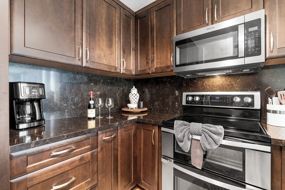 Fully Equipped Kitchen with Dark Wood Cabinetry