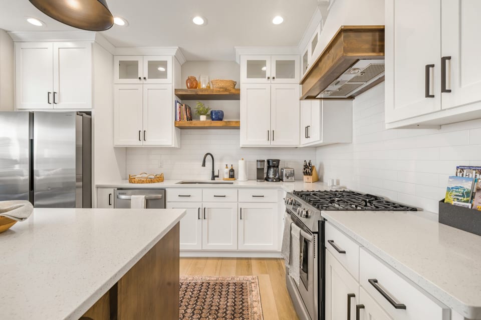 Modern kitchen with full appliances, gas stove, and double sink.