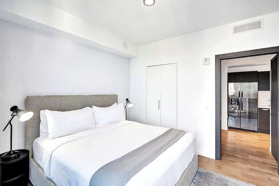 Second bedroom with clean white bedding