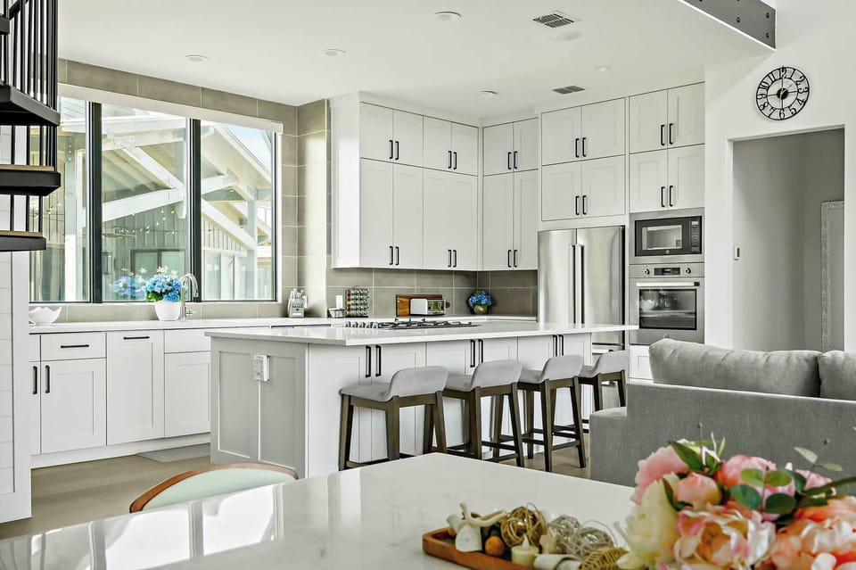 The chef-style kitchen is a true highlight, featuring high-end appliances, a spacious breakfast bar, and everything you need to whip up delicious meals