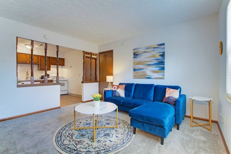 Living room with comfortable seating, Smart TV, and dining area nearby