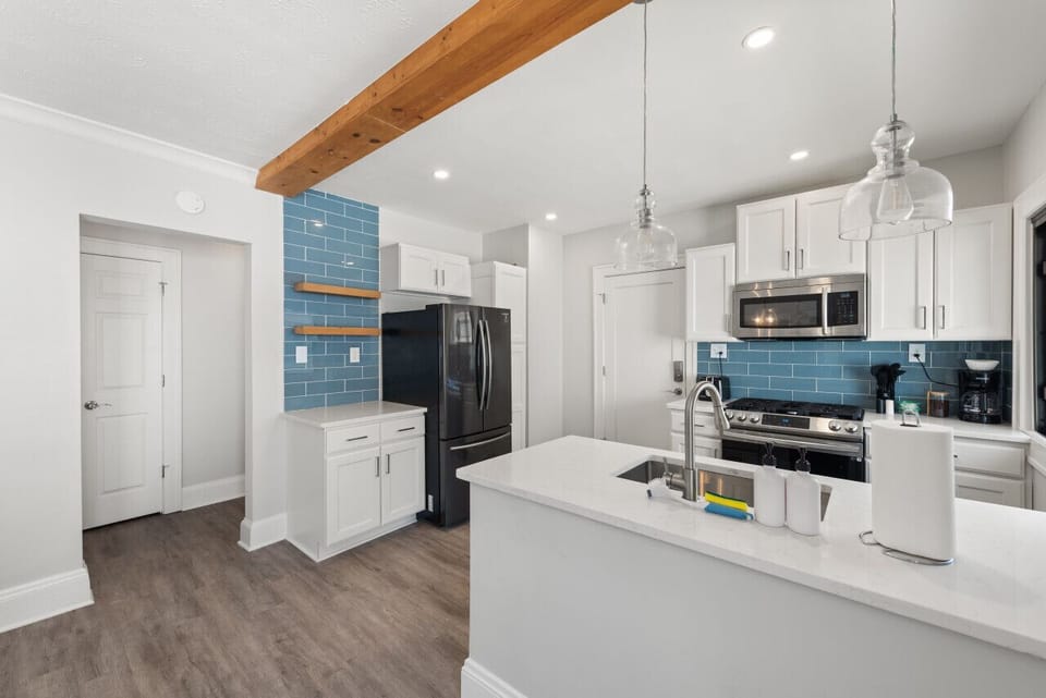 The fully equipped kitchen features modern appliances, generous counter space, and everything you need to prepare meals throughout your stay.