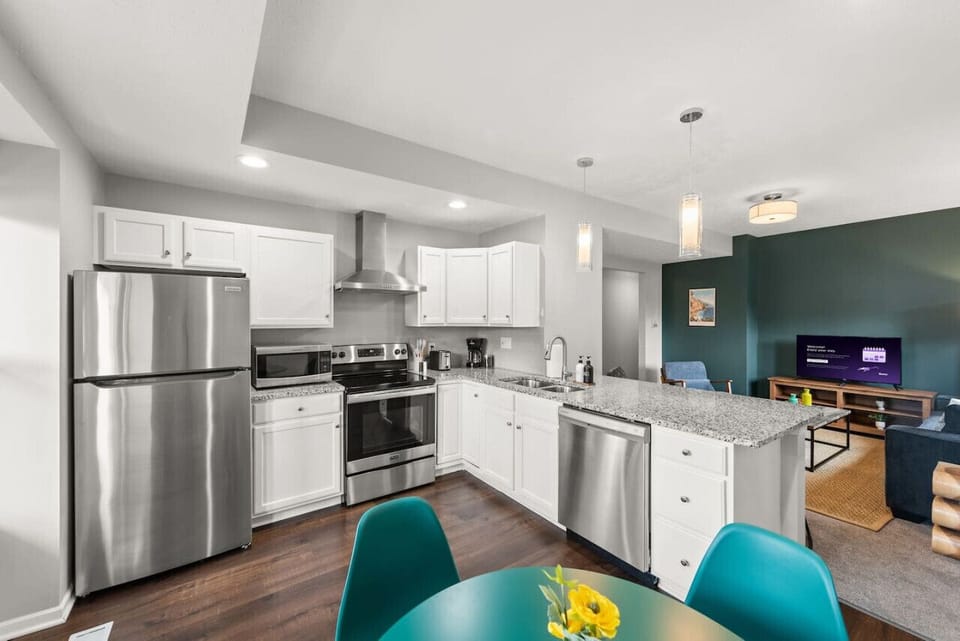 The open kitchen offers plenty of space for cooking while staying connected with family and friends in the adjoining living area.
