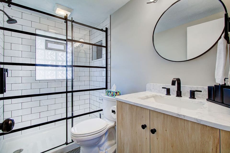 Updated full bathroom with a modern vanity and glass-enclosed shower.