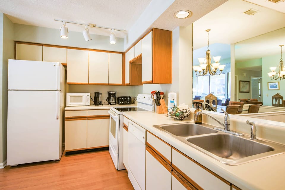 The kitchen features a dishwasher, range, refrigerator, toaster, drip coffee maker and keurig.