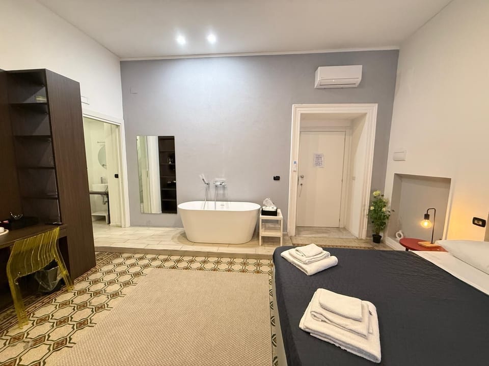 Deluxe Quadruple Room, Balcony, City View | In-room safe, blackout drapes, iron/ironing board, free WiFi