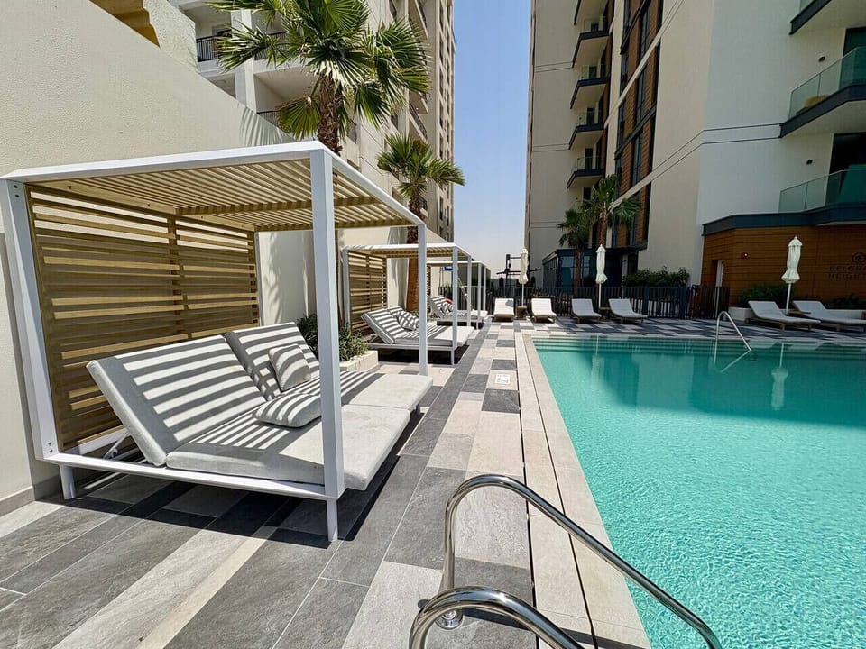 Poolside Oasis: Relax in stylish cabanas by the shimmering pool under sunny Dubai skies!