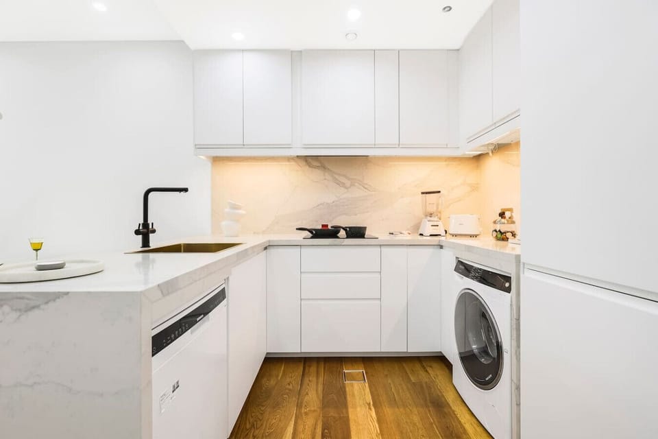 Kitchen: Sleek modern design with marble countertops and stylish appliances for culinary adventures!