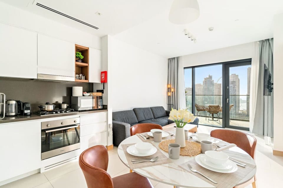 Living Area: Bright and airy space with modern decor and stunning skyline views for dining and relaxation!
