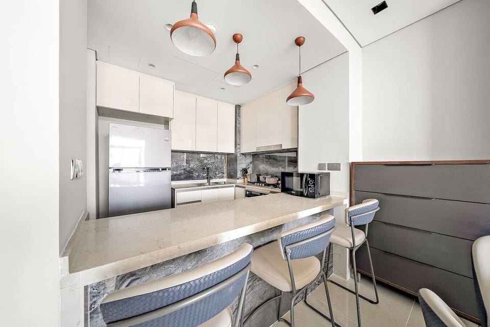 Modern Kitchen: Sleek design, equipped with stylish bar seating and top-notch appliances!