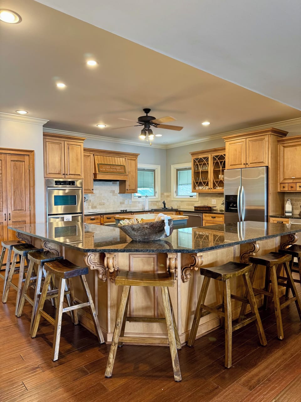 The large granite kitchen island provides additional seating for 8.