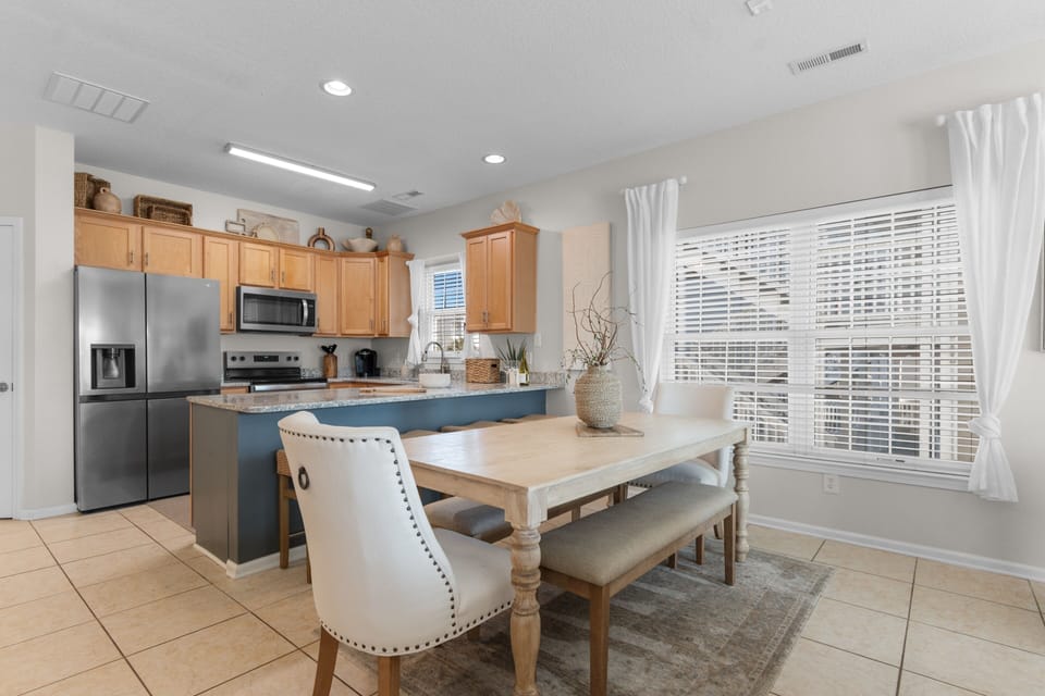 Picture yourself preparing meals in this spacious kitchen with modern appliances and ample counter space, then gathering at the inviting dining table where your group can share stories and laughter together.
