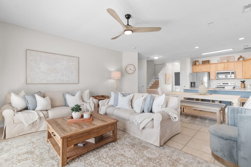 Sink into plush seating in your open-concept living area, where coastal tones and natural wood create a calming retreat for your group.