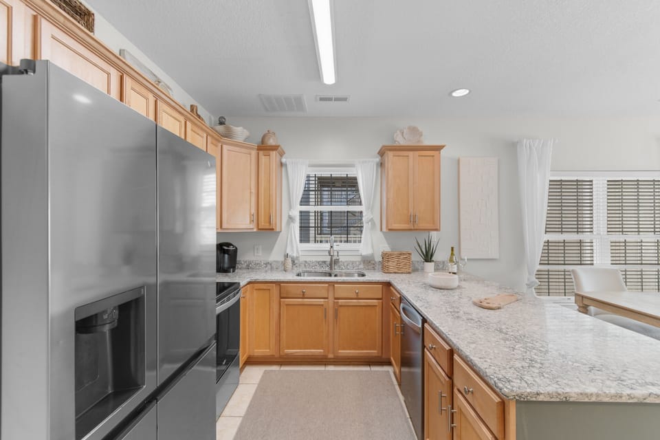 Step into your fully-equipped kitchen with spacious countertops, stainless-steel appliances, and warm natural light—perfect for preparing your favorite meals during your stay.