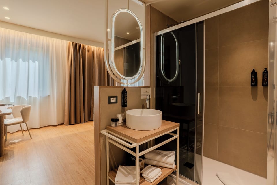 Deluxe Room, Multiple Beds, Non Smoking | Bathroom | Shower, hair dryer, bidet, towels