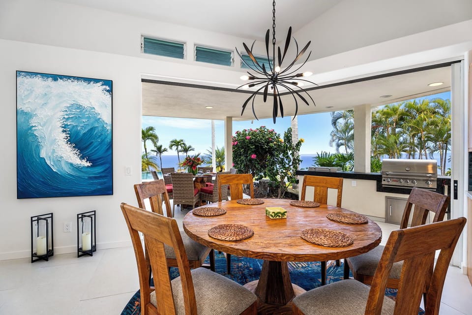 Dine in style beside floor-to-ceiling windows, where curated island artwork and lush garden scenes complement every mealtime moment.