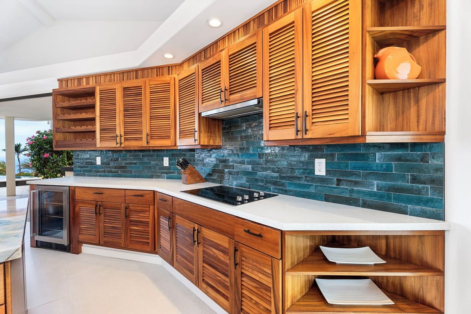 Elegant coastal kitchen stocked for home-cooked feasts, where form meets function with sleek finishes and thoughtful storage.