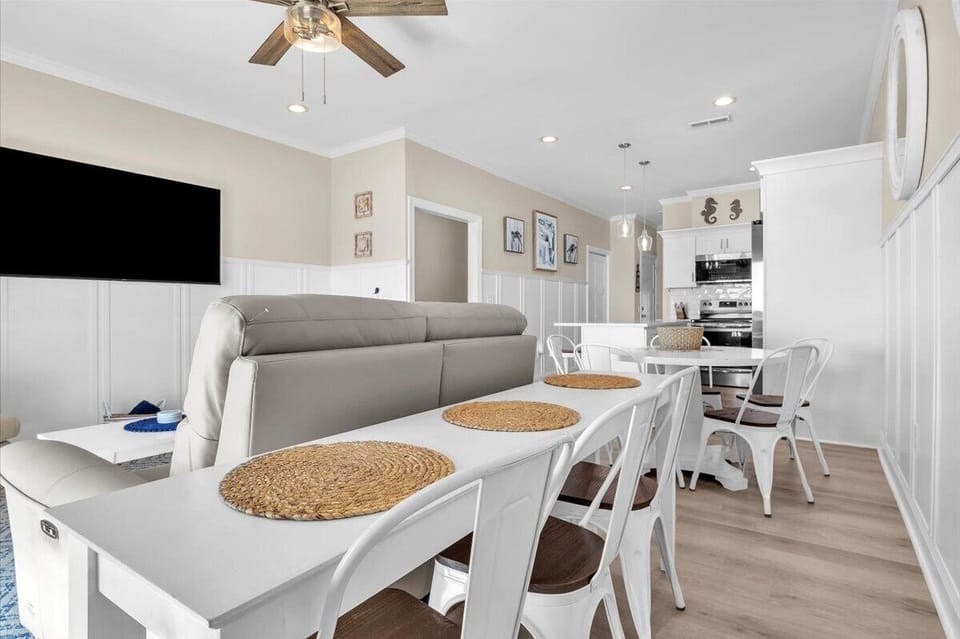Unwind in your bright open-concept space where coastal charm meets modern comfort—perfect for family meals and movie nights.