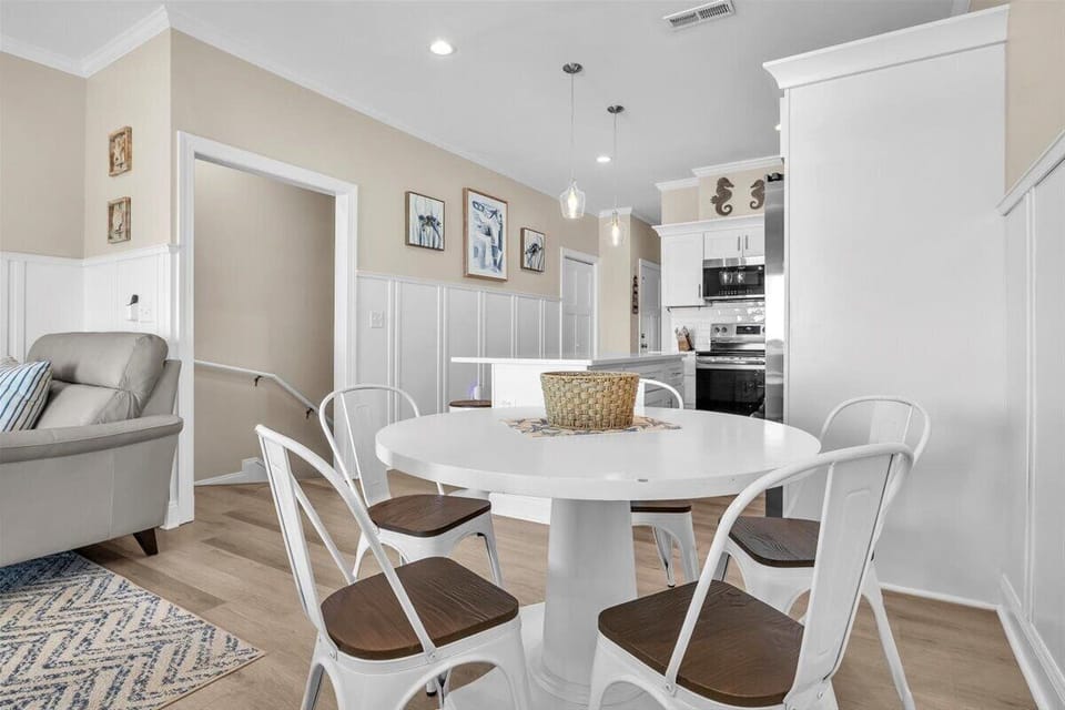 Gather around your stylish round table for memorable meals in this bright, open dining space that flows seamlessly into the kitchen.