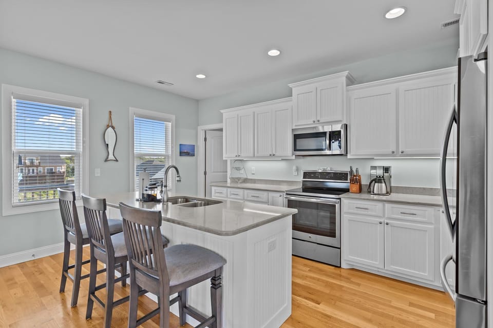 Sleek, Open-Concept Kitchen w/ Breakfast Bar Seating, Refrigerator, Oven, Stovetop, Microwave, and Much More