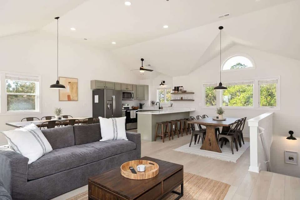Entertain in style at Yellow Lotus's expansive upper level, offering seating for 12 at the dining table, complemented by additional bar seating and outdoor picnic tables on the deck. Create unforgettable memories in this spacious gathering spot with