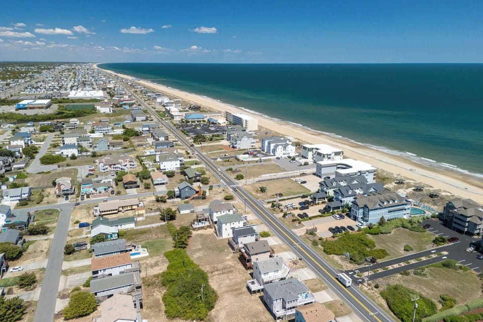 Kill Devil Hills features numerous public beach access points, including several with amenities like parking, showers, and lifeguard stations. 