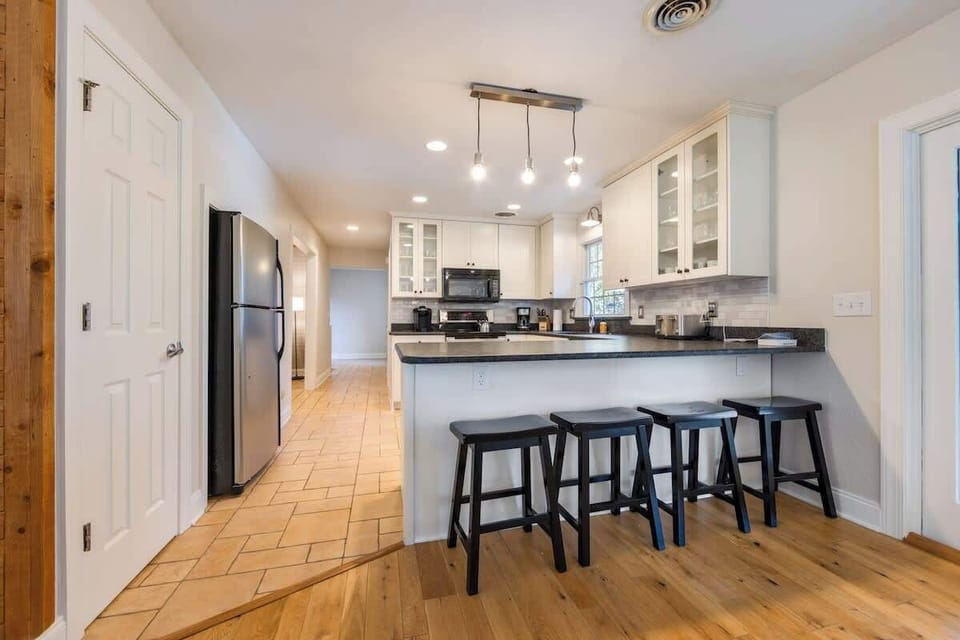 Entertain in style in this open and airy living room with dining space for 10! ✨ Enjoy gourmet meals prepared in the fully updated kitchen, equipped with all the amenities you need. Your perfect gathering space awaits! #HomeEntertaining #OpenConcept