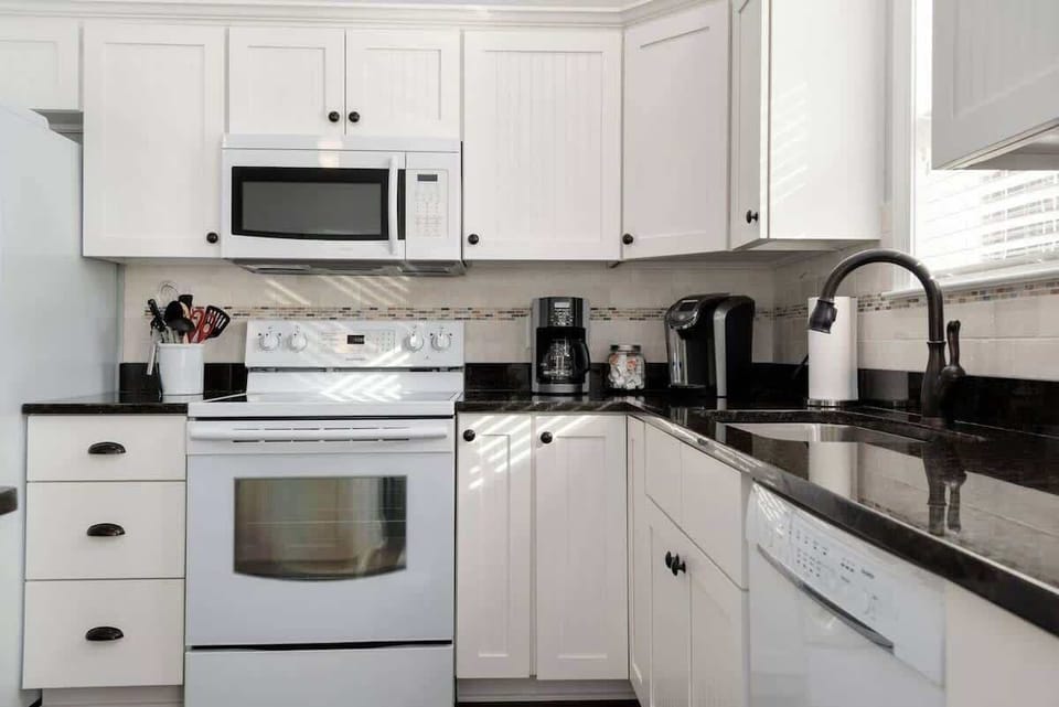 Clean kitchen with granite countertops. Microwave, Dishwasher, Electric Stove and Refrigerator with Water Dispenser and Ice Maker