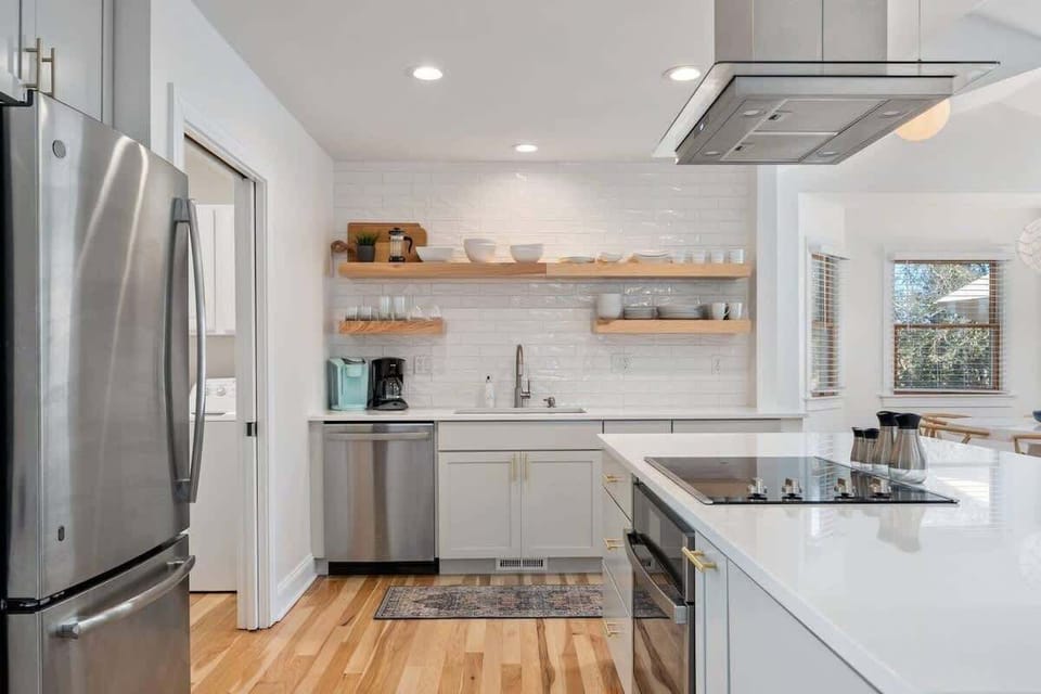 Featuring sleek quartz counters and a high-end suite of appliances - including a cooktop, oven, dishwasher,  refrigerator, and bar seating for 3—it’s designed for effortless entertaining. 