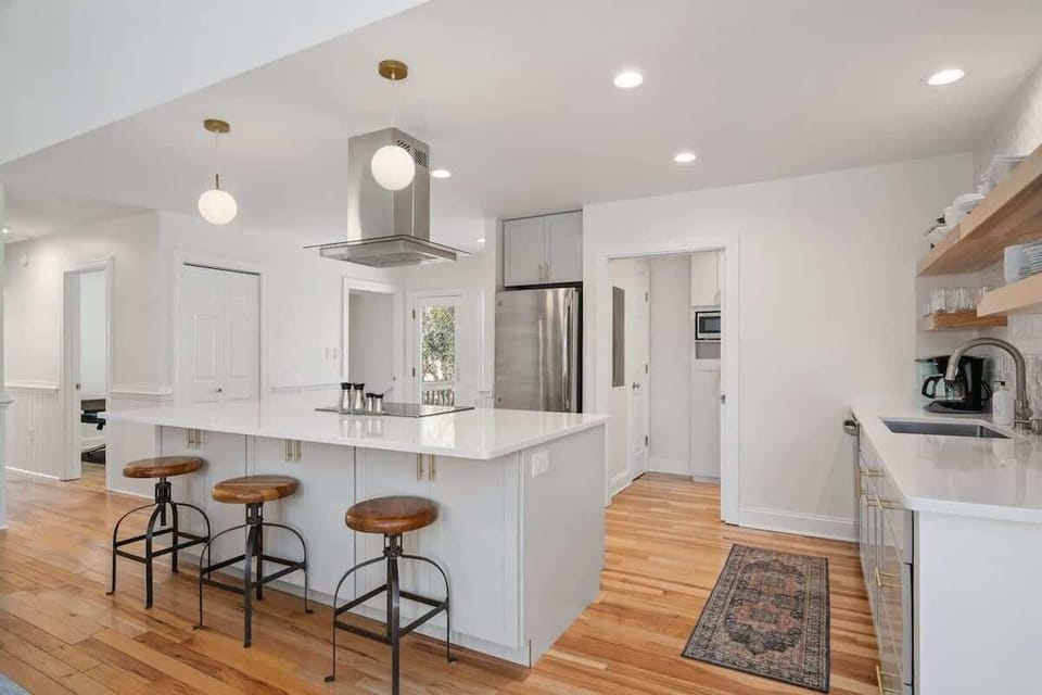 Featuring sleek quartz counters and a high-end suite of appliances - including a cooktop, oven, dishwasher,  refrigerator, and bar seating for 3—it’s designed for effortless entertaining. 