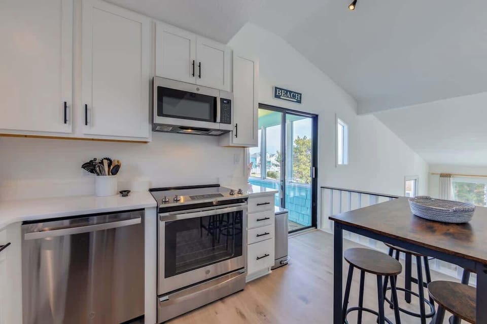 Step inside to discover a freshly updated interior boasting brand new floors and a modern kitchen, perfect for whipping up delicious meals after a day in the sun. Enjoy leisurely mornings and tranquil evenings on the screened porch.