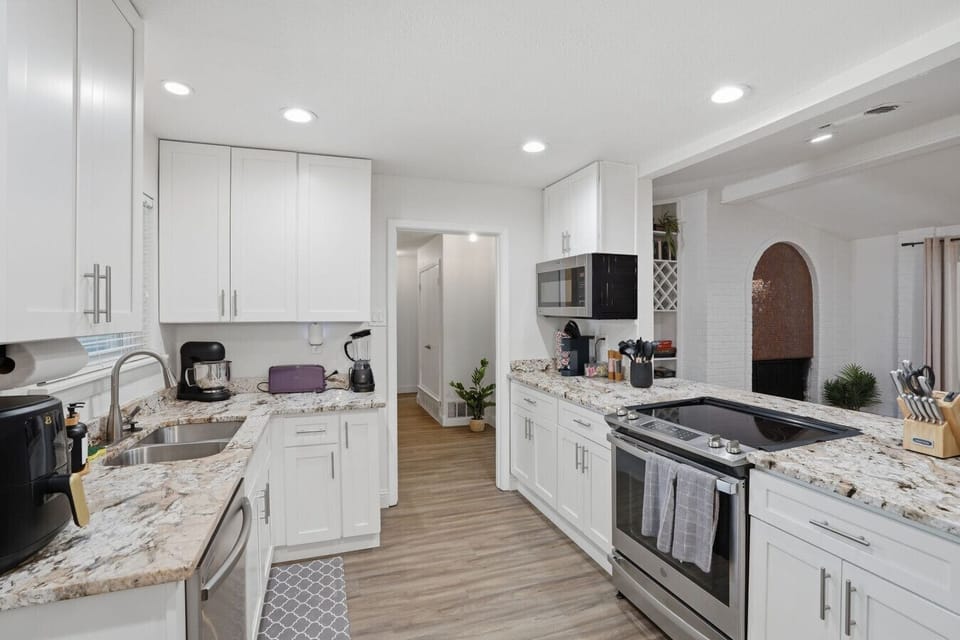 Well-appointed kitchen countertops stocked with a toaster, blender, coffee essentials, and cooking utensils — thoughtfully equipped so you can cook and dine together without a single grocery trip being inconvenient.