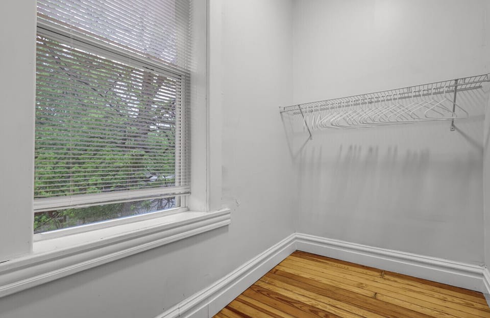 This closet offers ample room for your wardrobe with convenient hanging rods to keep everything neatly stored.