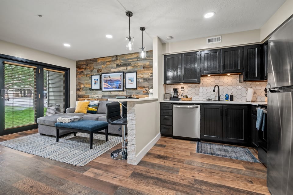 The kitchen features stainless steel appliances, including a microwave, stove, and spacious refrigerator.