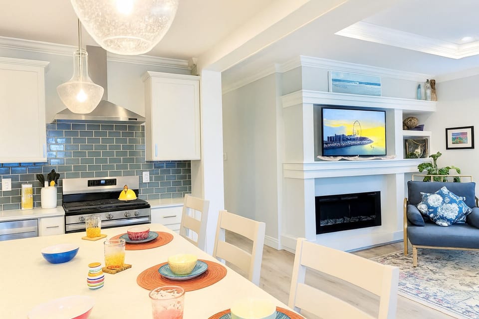 Gather around the island for breakfast or evening drinks while the fireplace and TV create the perfect cozy backdrop.
