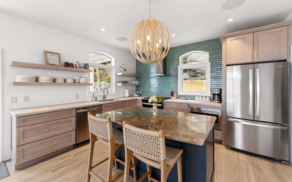 Fully stocked kitchen with stainless appliances, bar seating, coffee maker, blender, and all the tools to cook or sip in style. Enjoy free Wi-Fi throughout the villa.