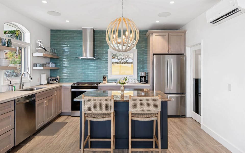 Fully stocked kitchen with stainless appliances, bar seating, coffee maker, blender, and all the tools to cook or sip in style. Enjoy free Wi-Fi throughout the villa.