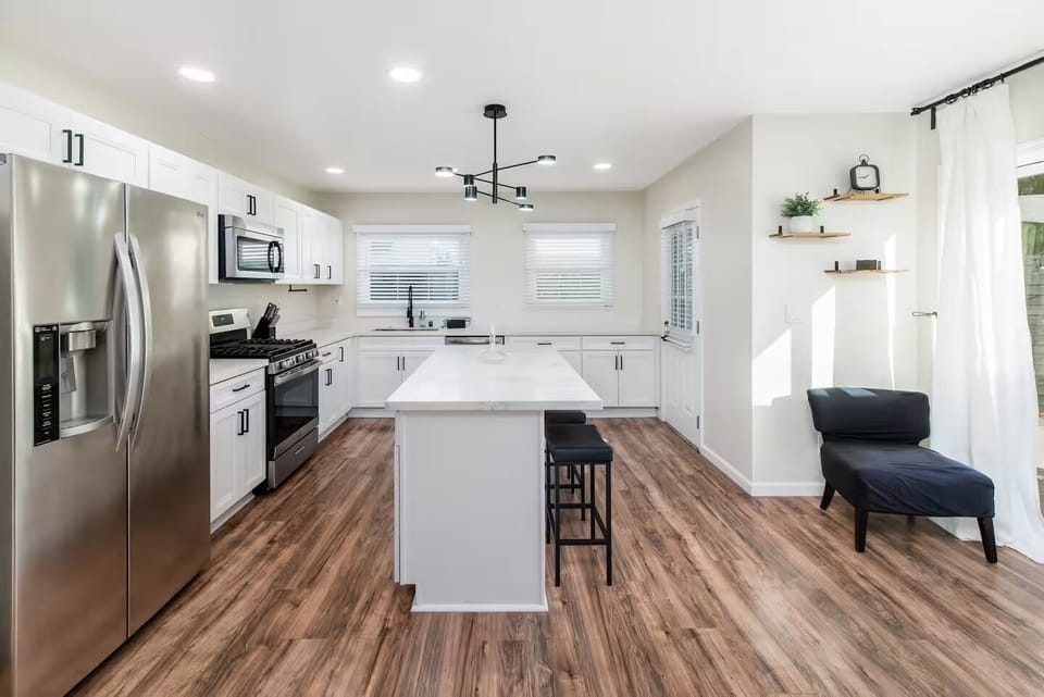 Bright modern kitchen with sleek white cabinets & center island